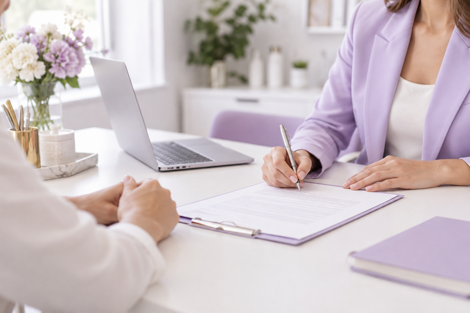 A professional office environment with a clean desk, a laptop, and a legal contract being signed und